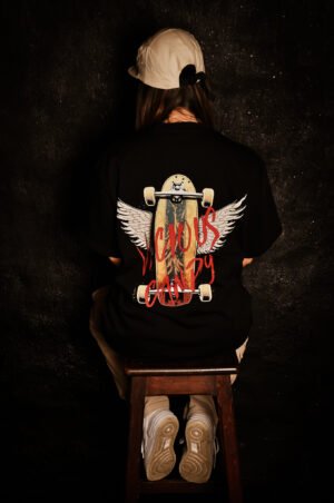 girl wearing Vicious Candy oversized black tee with skate and wings.