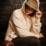 Girl wearing beige oversized beige Hoodie and Khaki cap