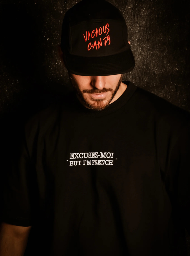 Man wearing Vicious Candy Black cap with red embroidery